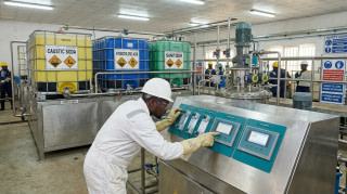 Chemical engineer monitoring a dosing skid for industrial chemical cleaning