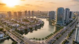 Aerial view of a modern Lagos waterfront neighbourhood with high-rise apartments and gated estates at golden hour